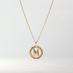 *The pendant COMES WITH the chain if you select one of our chain options *5% OFF TOTAL PRICE, when you purchase the chain and pendant combo (The price shown is after the discount) Level the way you wear a gold letter pendant. Stand out from the crowd and wear a solid gold letter pendant that outshines the typical lettering pendant. This 14K gold letter pendant redefines the way you wear a classic letter necklace. It presents the gold letter necklace in the most regal fashion, yet is still approp Letter M Pendant, Yellow Gold Initial Necklace With Monogram, M Initial Necklace, Regal Fashion, Gold Letter Pendants, M Initial, Initial Wreath, Gold Initial Pendant, Gold Wreath