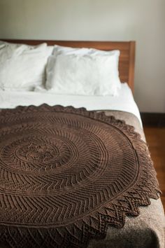 a bed with a brown blanket on top of it