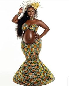 a pregnant woman wearing a colorful dress and headpiece with her hands on her hips