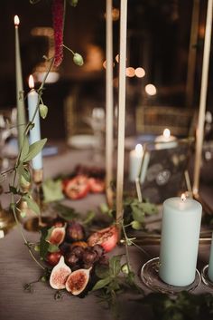 the table is set with candles and figs