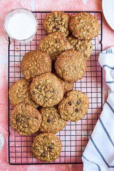 cookies on a cooling rack next to a glass of milk