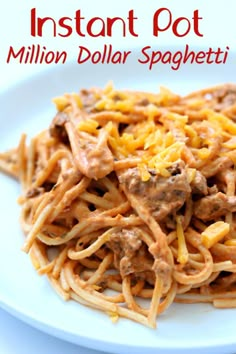 spaghetti with meat and cheese on a white plate