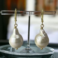 These are irregular pear shaped baroque pearls, they are elongated, natural color, lustrous! For a simple, minimalist look. This Baroque Pearl Dangling Earring is made with genuine baroque pearls, handmade, carefully wire wrapped in gold filled wire.   The shape is pear, elongated with irregular shape, rounded at the bottom. The pearls do not have the same exact measurements, one maybe slightly smaller than the other. Pls see photos for approx measurements.  I used a simple gold filled leverback Elegant Pearl Jewelry, Pink Gift Box, Baroque Pearl Earrings, Jewelry Care Instructions, Earrings In Gold, Support Handmade, Elegant Jewelry, Baroque Pearls, Minimalist Earrings