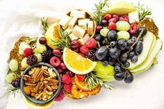 an assortment of fruits and nuts arranged on a platter