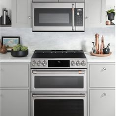 a stainless steel stove and microwave in a kitchen