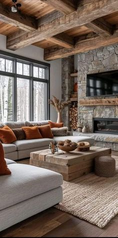 a living room filled with lots of furniture and a flat screen tv mounted to the wall