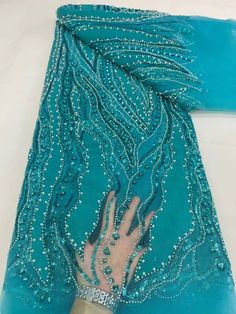 This high quality Fabric is measured in 5 Yards With Embroidered Beading and Sequin. It is soft, very delicate and beautiful. This high Quality Fabric is made with Fashion embroidered rhinestones can be used in making party wedding dresses, skirts, shawls, scarves and other other fashion apparels as you would like. Size : Length : 5 yards (180 inch). Width: 50 inch (Please allow slight deviation for the measurement data ,±1 inch) Material: 100% Polyester, Tulle Lace Fabric, Eco-Friendly embroide Elegant Embroidered Fabric With Rhinestones For Festive Season, Elegant Embroidered Fabric With Rhinestones For Festive Occasions, Fitted Embroidered Fabric With Rhinestones For Evening, Fitted Embellished Embroidered Fabric For Banquet, Fitted Embroidered Fabric With Rhinestones For Festive Occasions, Elegant Rhinestone Embroidered Fabric For Banquet, Elegant Embroidered Fabric With Rhinestones For Party, Beaded Organza Embroidered Fabric For Party, Elegant Green Sequin Fabric For Wedding