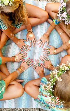 a group of women sitting around each other with their hands together