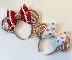 two minnie mouse ears are decorated with christmas decorations