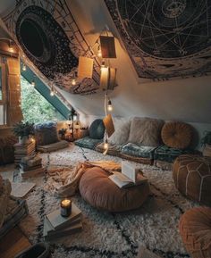 a room with lots of pillows and lights on the ceiling