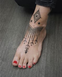 a woman's foot with a tattoo on it