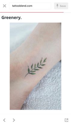 a small green leaf tattoo on the ankle