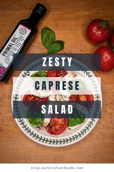 a plate with tomatoes and basil on it that says zesty caprese salad