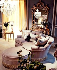 a living room filled with furniture and a chandelier