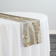 a white table topped with a gold cloth