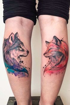 two women's legs with tattoos on them, one has a fox and the other is