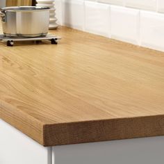 a wooden counter top in a kitchen with white walls