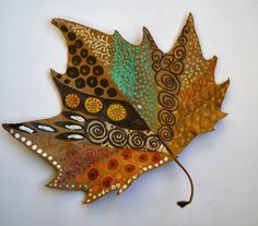 a decorative leaf is hanging on the wall