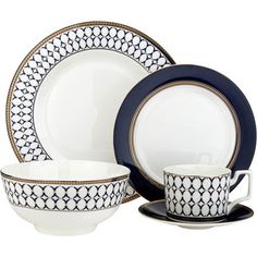 a white and blue dinner set with black trimmings