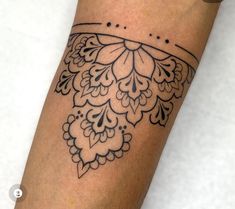 a woman's arm with a tattoo design on it, which is decorated with flowers