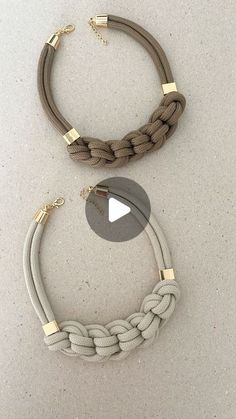 two different necklaces are shown on the floor, one is gray and one is beige