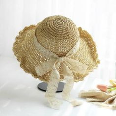 Stay cool and stylish with our natural straw hat, designed with a wide brim and scalloped edge for excellent sun protection. The lightweight and breathable material, combined with an open weave pattern, ensures maximum airflow to keep you comfortable. A delicate lace ribbon bow adds an elegant touch, while the adjustable inner band offers a secure and perfect fit. Ideal for beach outings, garden parties, and picnics, this hat provides both functionality and a feminine look for any summer occasio Lightweight Cream Straw Hat For The Beach, Lightweight Cream Straw Hat For Beach, Lightweight Cream Straw Sun Hat, Casual Crochet Lace Hat For The Beach, Beach Hat With Adjustable Crochet Lace, Cream Straw Sun Hat For Summer, Straw Hat For Garden Party, Beach Hat With Crochet Lace And Adjustable Fit, Straw Sun Hat For Garden Party