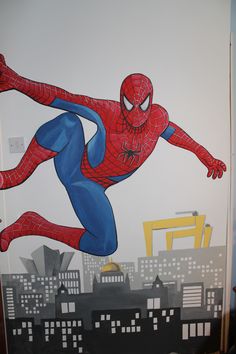 a painting of a spider man is on the wall