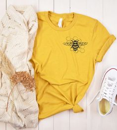 Check out this cute  earth day bee shirt. Perfect gift for any beekeeper.  This shirt is printed by Monster digital which is a US company.  This is printed on the unisex Bella and canvas 3001 T shirt.  Unfortunately we do not offer returns or exchanges as these are printed per order. If you have any manufacturing issues we will do our best to make it right.   This classic unisex jersey short sleeve tee fits like a well-loved favorite. Soft cotton and quality print make users fall in love with it Bee Shirt Ideas, Bee Themed Classroom, Earth Day Shirt, Bee T Shirt, Bee Shirt, Res Life, Auntie Shirts, Buy Shirts, Bee Design