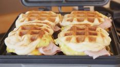 three waffles with ham and cheese on them