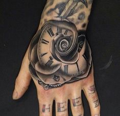 a person's hand with tattoos on it and a clock tattooed on the palm