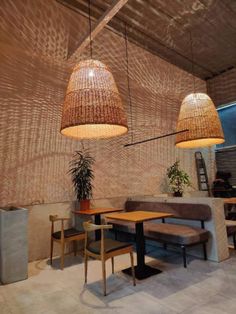 two lamps hanging from the ceiling in a restaurant