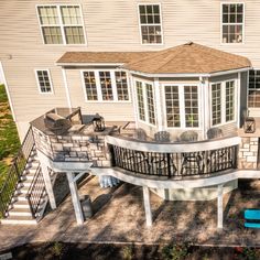 an aerial view of a house with a deck and patio area in the foreground