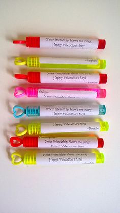 four different colored pens sitting next to each other on top of a white surface with the words happy valentine's day written on them