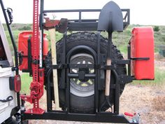 the back end of a truck with tools attached to it's tires and tire