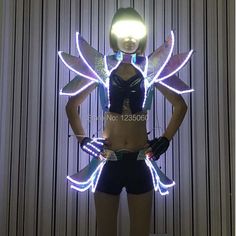 a mannequin with wings and lights on it's chest, standing in front of a wall