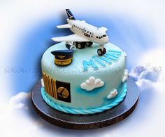 a blue cake with an airplane on top