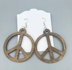 Laser cut wooden peace sign earrings  Stained with a dark walnut finish. Approximately 2 inches by 2 inches Wooden Peace Sign, Peace Sign Earrings, Wooden Earrings, Dark Walnut, Walnut Finish, Peace Sign, Laser Cut, Jewelry Earrings Dangle, Etsy Earrings