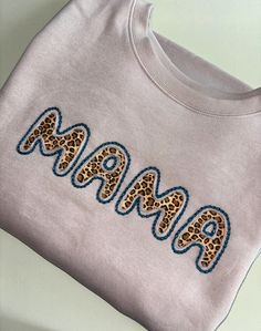 Mama Sweatshirt-Custom Embroidered Sweatshirt-Mother's Day Gift-Custom Sweatshirt-Crewneck Sweatshirt-Gift for Mom-Mom Gift-Mom Sweatshirt-Gift for Her-Mama Custom Embroidered MAMA Sweatshirt makes for a great gift for Mom. This custom sweatshirt also makes for the perfect Mother's Day Gift. This crewneck sweatshirt is super soft and makes for a spectacular gift for her (or anyone). Main photo shows Beige Mama sweatshirt with Cheetah fabric and Peacock chain stitch embroidery outline. MAMA sweat Pink Crew Neck Sweatshirt With Machine Embroidery, Casual Sweatshirt With Custom Embroidery For Mother's Day, Mother's Day Crew Neck Sweatshirt With Letter Embroidery, Mother's Day Embroidered Crew Neck Sweatshirt, Embroidery Outline, Chain Stitch Embroidery, Great Gifts For Mom, Mama Sweatshirt, Sweatshirt Crewneck