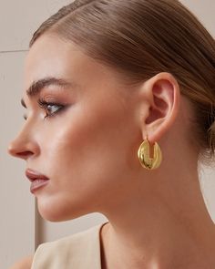 These medium-sized hoop earrings feature a sleek, modern twist on the classic design, with a rectangular gap adding a unique touch. Crafted in 18K gold plated over sterling silver, they exude luxury with a flawless hand-polished finish. Thanks to our exclusive Italian electroforming technology, these hoop earrings remain lightweight and comfortable for long wear. Available in both yellow gold for a rich look or white gold for a cool, polished vibe, they make a perfect gift for her, gift for mom, Bamboo Hoop Earrings, Earring Sale, Perfect Gift For Her, Designer Earrings, Shop Earrings, Post Earrings, Gold Color, Jewelry Pieces, 18k Gold