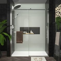 a bathroom scene with focus on the shower door and towel rack, rugs and potted plant