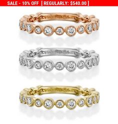 four different colored gold and silver rings with diamonds on each one, all in different sizes