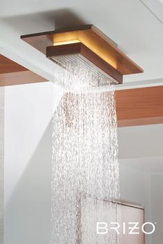 a shower head with water running down it's side and the words brizo above it