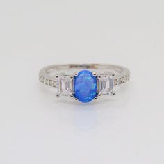 Sterling Silver Blue Opal & White Topaz Ring ...Marked 925...Total of weights 2.0grams...Size 7...Measure of Stone center 6.5 x 4.5MM...It's in very good condition. Oval Blue Opal Ring Hallmarked, Classic Blue Opal Ring For Anniversary, Blue Opal Ring With Accent Stones For Anniversary, Topas Ring, Silver Leaf Ring, Large Stone Rings, White Opal Ring, Carved Ring, Opal Earrings Stud