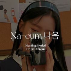 a woman holding a camera up to her face with the words nam - eeun lee on it