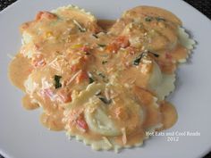 some ravioli with cheese sauce on a white plate