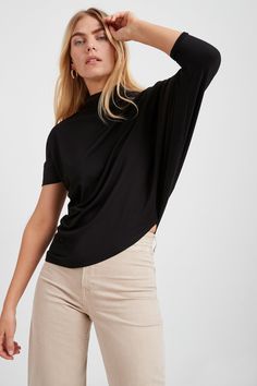 "Stunning day-to-night style. A tale of two halves, our Hamilton Top is all about eye-catching and versatile asymmetry. Crafted from soft, high-stretch and sustainable European jersey with a relaxed fit, she's designed with a dropped-shoulder short sleeve on one side and a mid-length batwing sleeve that drapes down your arm on the other. An asymmetric bottom hem creates a slant on the hip. The look is pure geometric chic. MODEL INFO: Maritza, in black, is 5'9\" (177 cm) tall, wearing size XS. Na Batwing Shirt, Batwing Top, Night Style, Sweatshirt Fabric, Mock Neck Top, Fashion Night, Oversized Top, Batwing Sleeve, Ethical Fashion