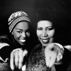 two women pointing at the camera and smiling