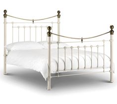 a white metal bed frame with two posts