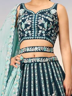 This stunning ensemble features a teal blue color satin lehenga with intricate sequin and coding thread embroidered work, paired with a matching satin choli adorned with the same exquisite details. The look is completed with a sky-blue georgette dupatta featuring a sequin work ethnic motif and embroidery cut work border.
The teal blue lehenga is semi-stitched up to 42 inches with a 3.0-meter flair, allowing for a perfect fit. The un-stitched choli material gives you the freedom to customize the Blue Party Wear Traditional Outfit With Intricate Embroidery, Blue Party Wear Traditional With Intricate Embroidery, Blue Traditional Wear With Intricate Embroidery For Party, Blue Party Wear Sets With Intricate Embroidery, Blue Fitted Palazzo Set With Intricate Embroidery, Fitted Blue Palazzo Set With Intricate Embroidery, Bollywood Style Embroidered Turquoise Sets, Designer Embroidered Turquoise Lehenga, Designer Turquoise Embroidered Lehenga