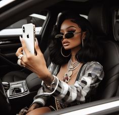 a woman sitting in the driver's seat of a car using her cell phone